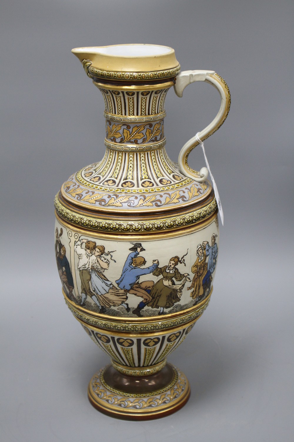 A large Villeroy and Boch Mettlach ewer, decorated with figures drinking, dancing and musicians, impressed 1159, height 45cm